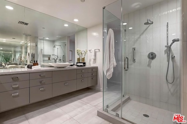 bathroom featuring vanity, an enclosed shower, and tile patterned floors