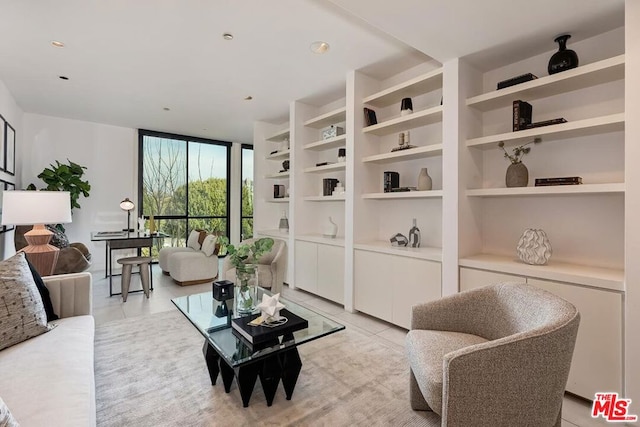 living area featuring expansive windows, light tile patterned flooring, and built in shelves