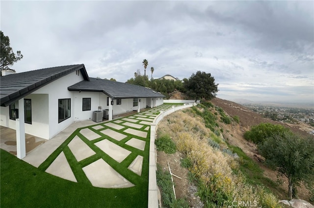 view of yard with a patio and central air condition unit