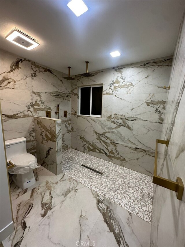 bathroom with toilet and tiled shower