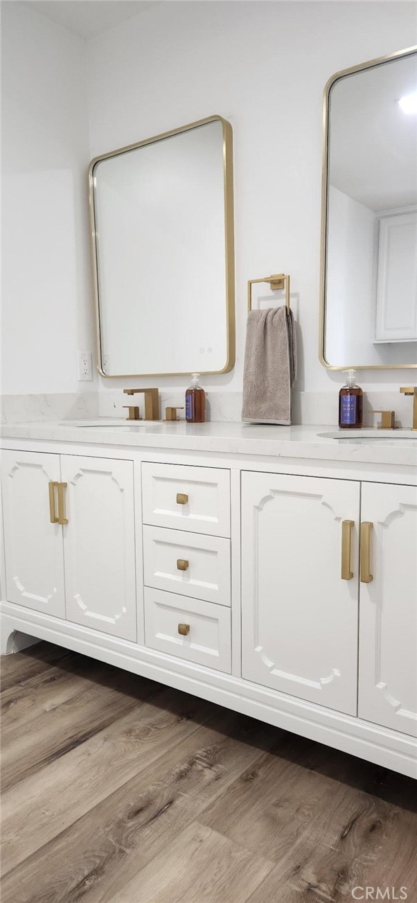 interior details with vanity and wood-type flooring