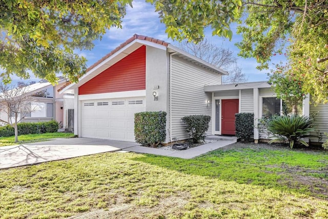 view of front of house featuring a garage and a front lawn