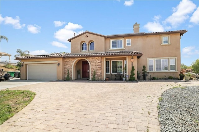 mediterranean / spanish-style house with a garage