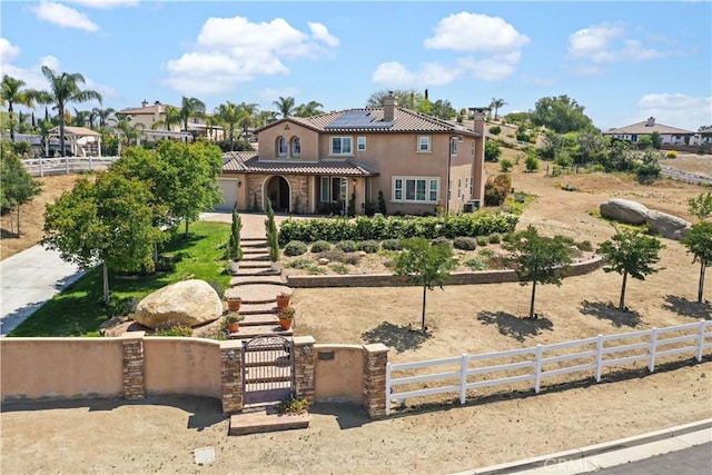 mediterranean / spanish home featuring solar panels