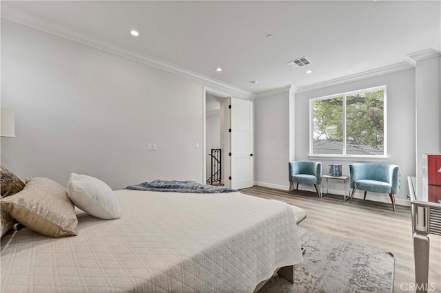 bedroom featuring ornamental molding and hardwood / wood-style floors