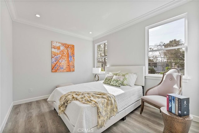 bedroom with multiple windows, crown molding, and hardwood / wood-style floors