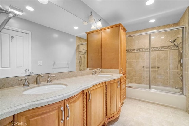 bathroom with vanity, tile patterned flooring, and combined bath / shower with glass door