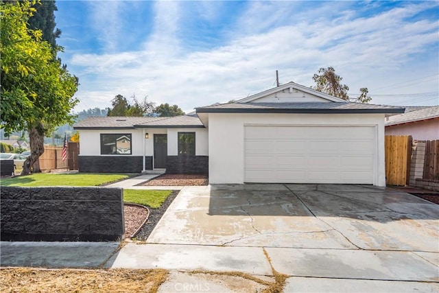 ranch-style home featuring a garage and a front yard