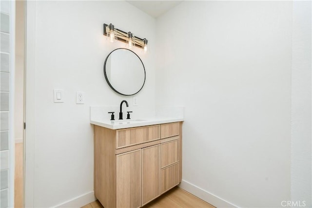 bathroom featuring vanity and hardwood / wood-style floors