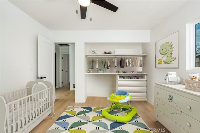 bedroom with light hardwood / wood-style flooring and ceiling fan