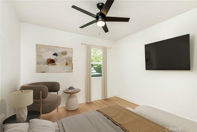 living room with wood-type flooring and ceiling fan