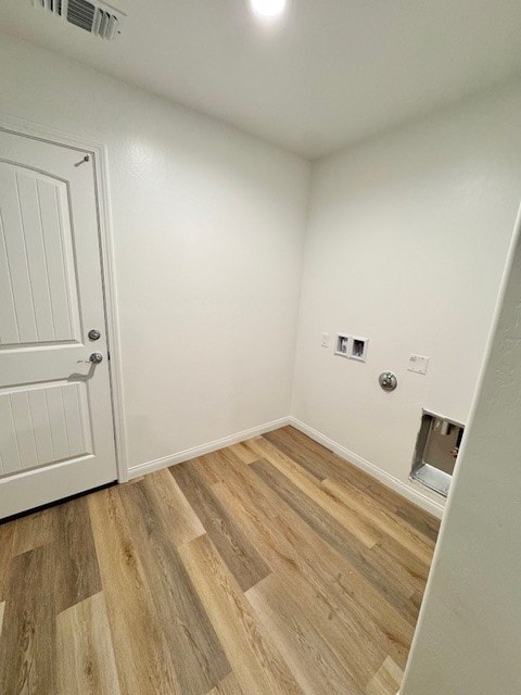 clothes washing area featuring washer hookup, light hardwood / wood-style floors, and electric dryer hookup