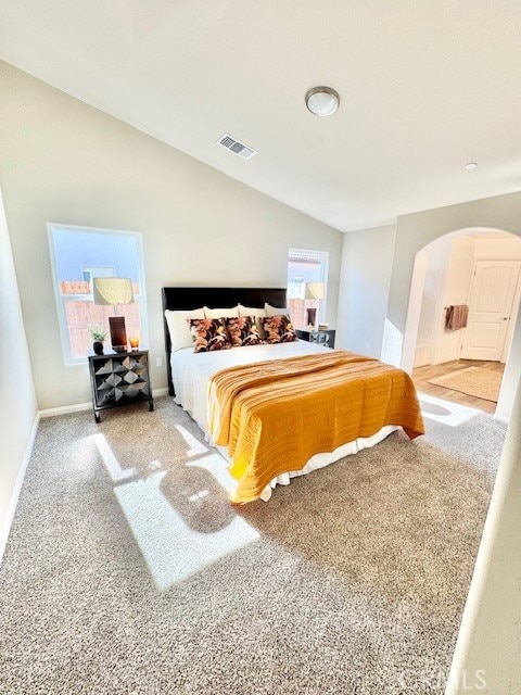 carpeted bedroom featuring vaulted ceiling