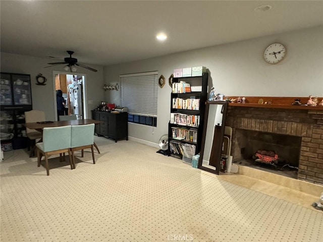 living room with a fireplace and ceiling fan