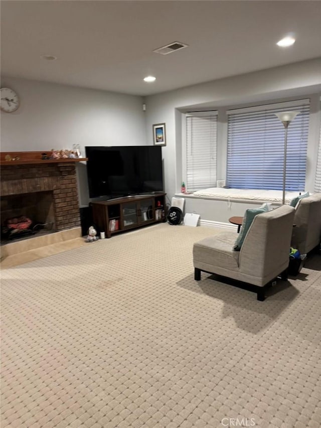 living room with light carpet and a brick fireplace