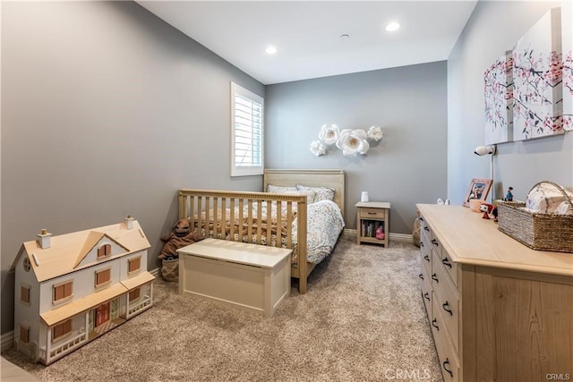 bedroom with recessed lighting, light carpet, and baseboards