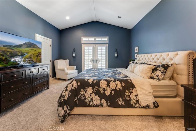 bedroom featuring lofted ceiling and light colored carpet