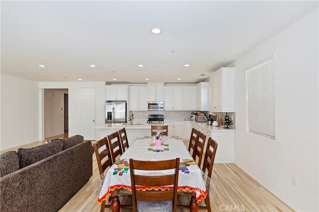 dining room with sink and light hardwood / wood-style floors