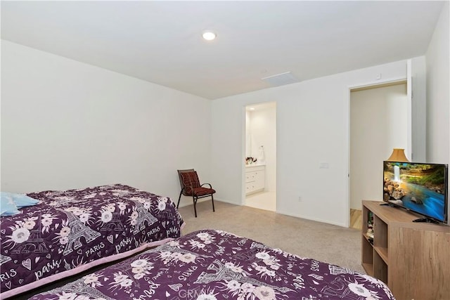 carpeted bedroom featuring ensuite bathroom