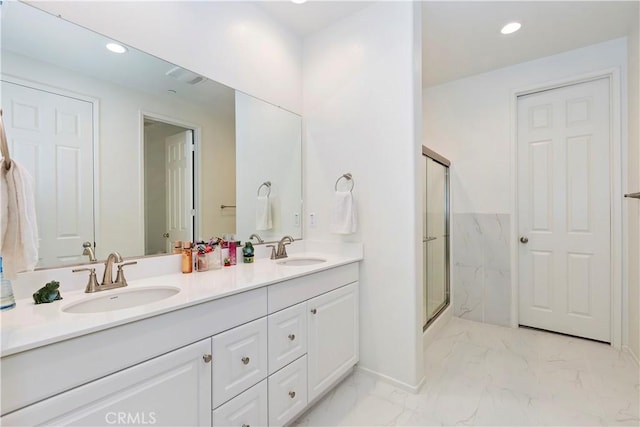 bathroom with vanity and an enclosed shower