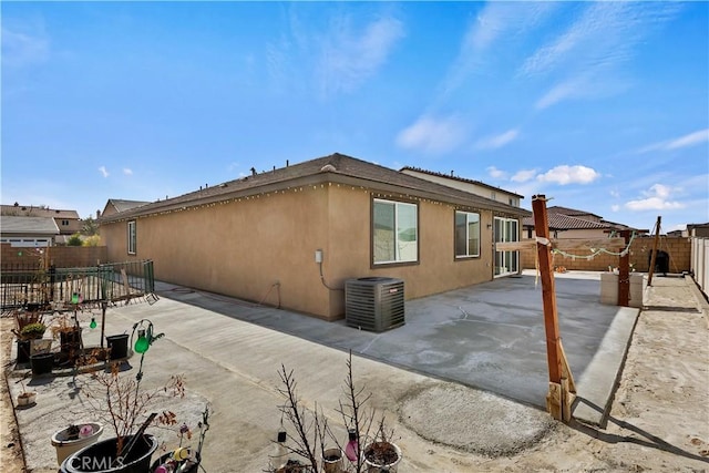 view of side of home featuring central AC unit and a patio