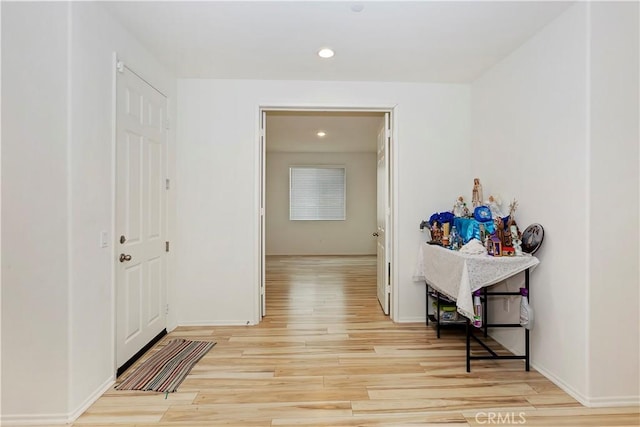 corridor with light hardwood / wood-style floors