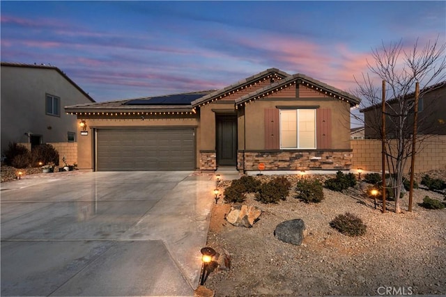 view of front of house with a garage and solar panels