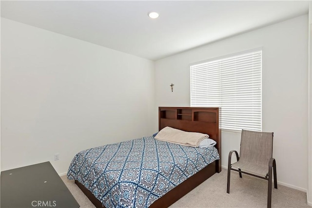 carpeted bedroom with multiple windows