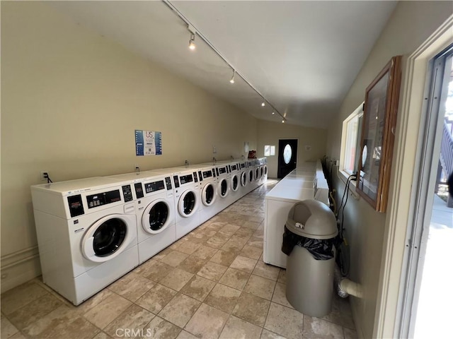 laundry area featuring track lighting and washing machine and dryer