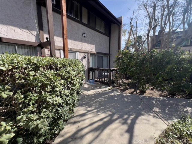 exterior space with a patio area and stucco siding