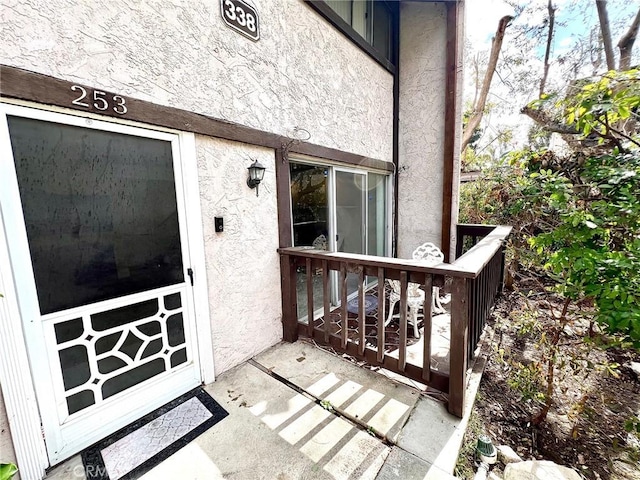 property entrance with stucco siding