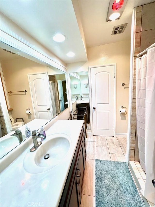 bathroom featuring vanity and curtained shower