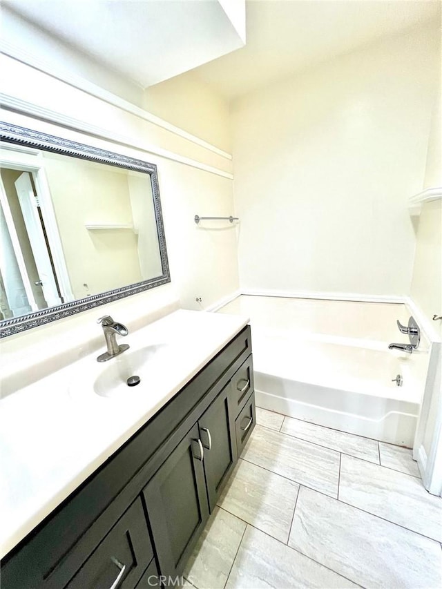 bathroom featuring vanity and a washtub