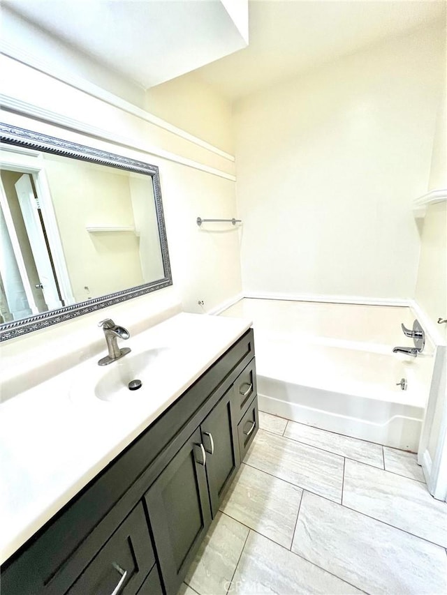 bathroom with a bath and vanity