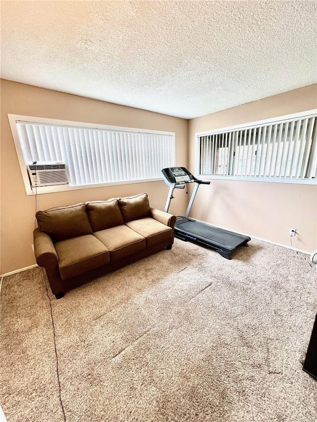 exercise area featuring carpet floors, cooling unit, and a textured ceiling