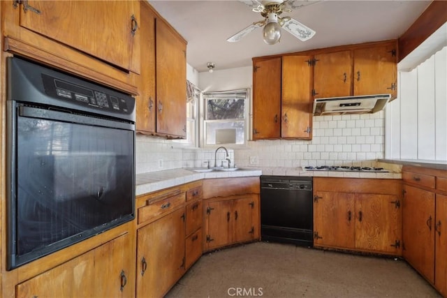 kitchen featuring sink, backsplash, tile counters, ceiling fan, and black appliances