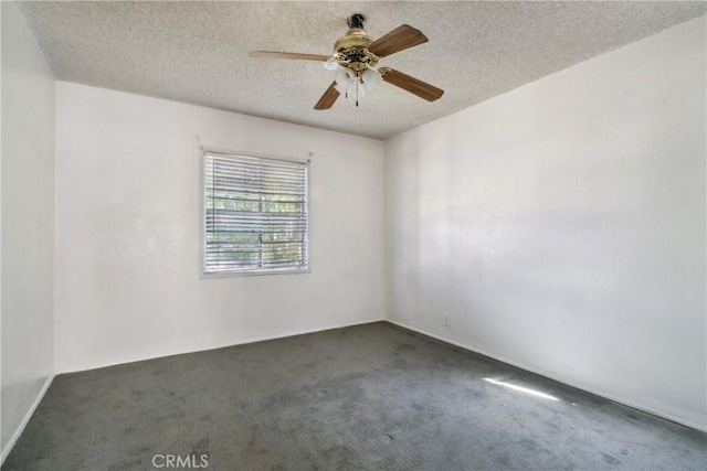 carpeted empty room with ceiling fan and a textured ceiling