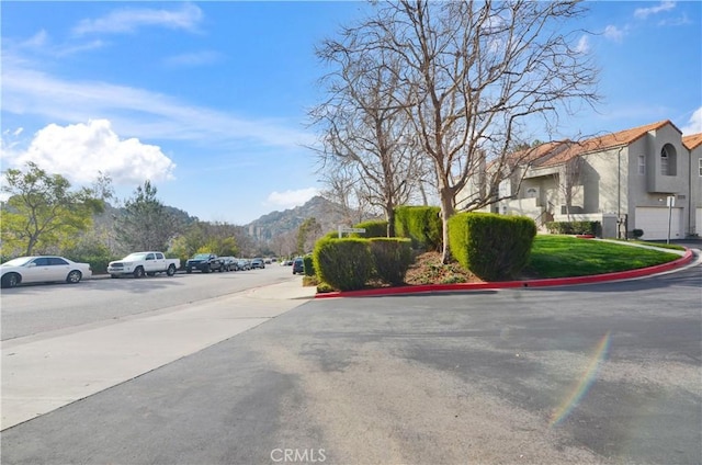 view of road with curbs and a mountain view