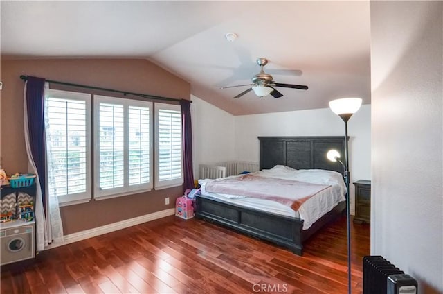 bedroom with radiator, a ceiling fan, vaulted ceiling, wood finished floors, and baseboards