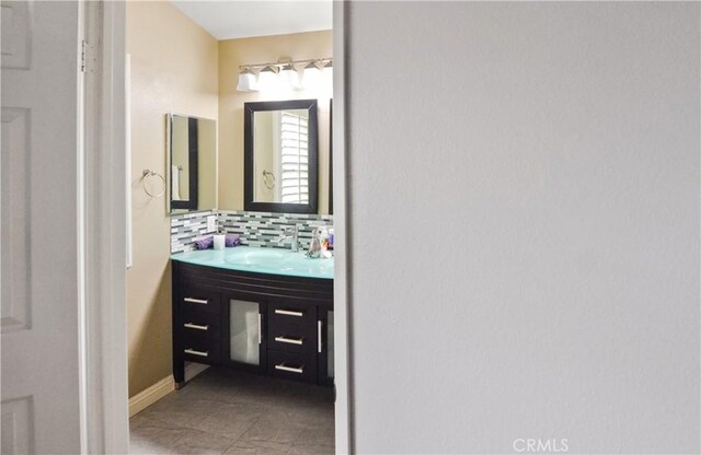 bathroom with tasteful backsplash and vanity