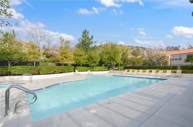 community pool with a patio area