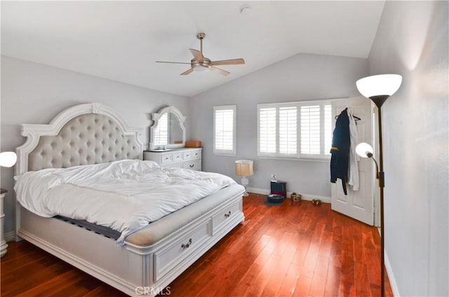 bedroom with lofted ceiling, baseboards, dark wood finished floors, and a ceiling fan