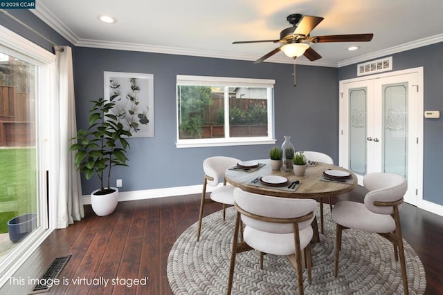 dining area featuring ornamental molding, dark hardwood / wood-style flooring, and french doors