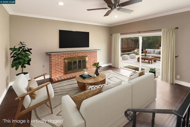 living room with ceiling fan, ornamental molding, hardwood / wood-style floors, and a brick fireplace