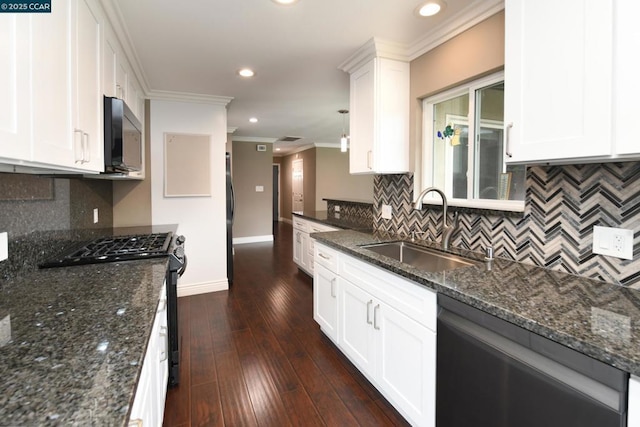 kitchen with sink, white cabinetry, dark stone countertops, ornamental molding, and black appliances