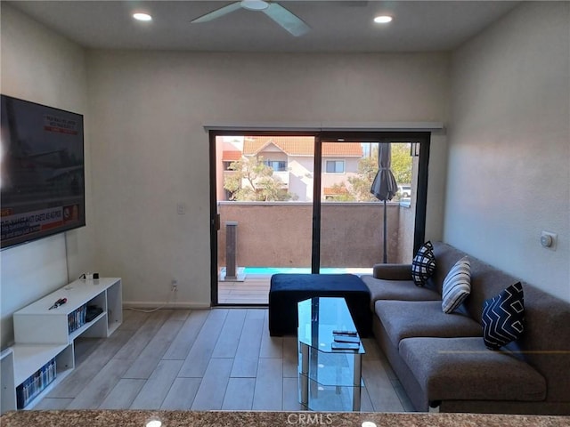 living room featuring light hardwood / wood-style floors and ceiling fan