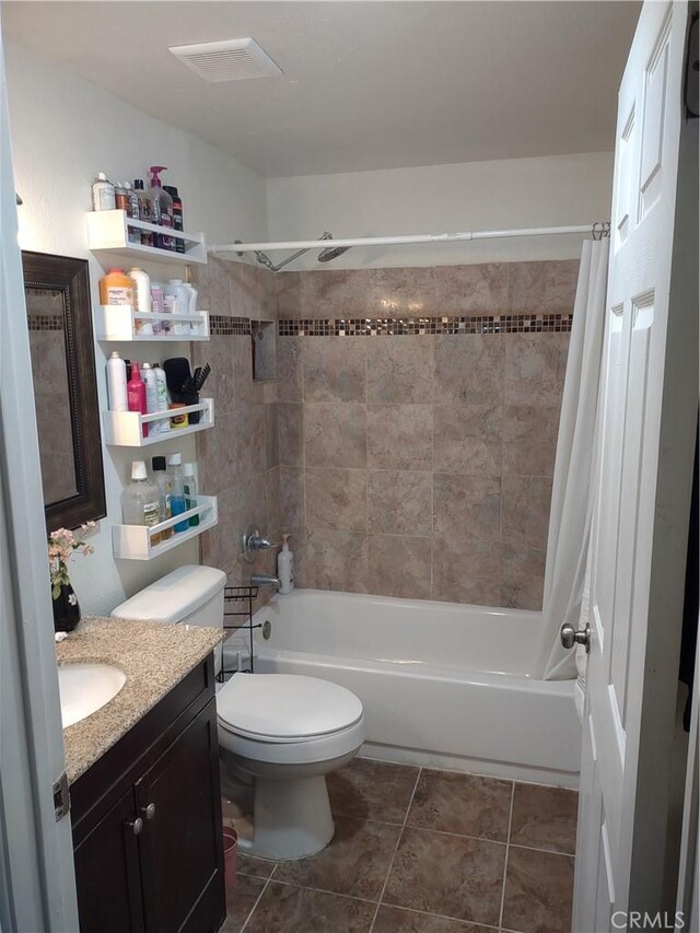 full bathroom featuring vanity, tile patterned floors, toilet, and shower / bath combo