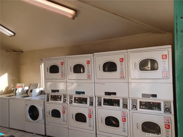 clothes washing area featuring washing machine and dryer and stacked washing maching and dryer