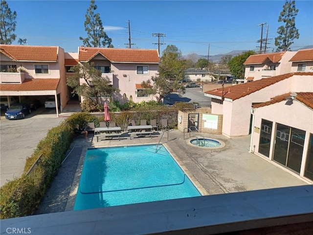 view of swimming pool with a patio and a community hot tub