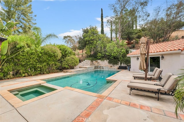 view of swimming pool with a patio and an in ground hot tub